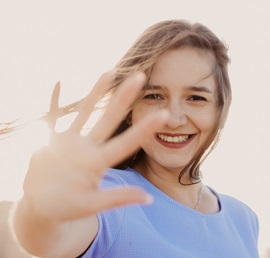 A shallow focus photo of a woman in a blue top